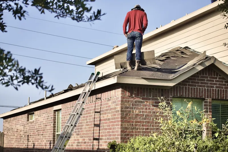 Professional roofer working on a residential roof in Robbinsville